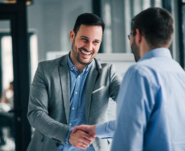 Man smiling whilst shaking hand-00