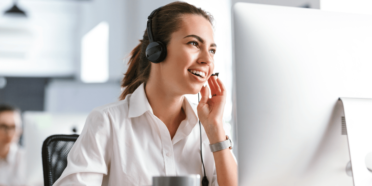 canva-woman-smiling-talking-on-headset