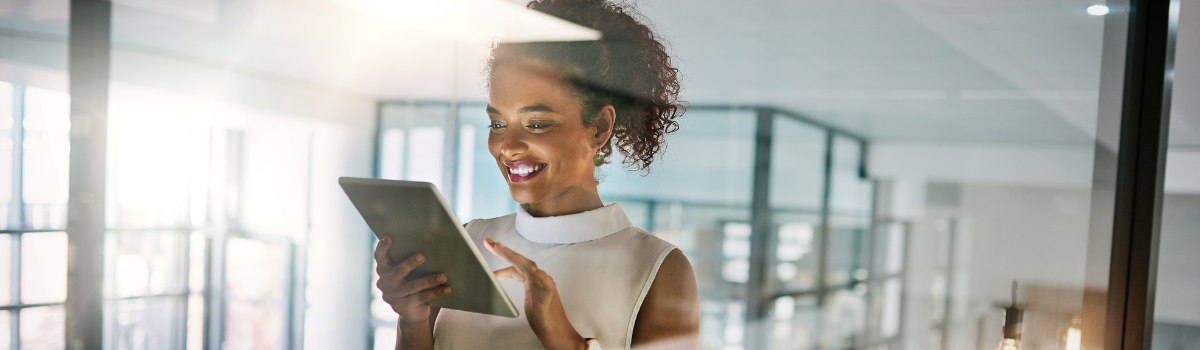 canva-woman-with-tablet-smiling-through-glass