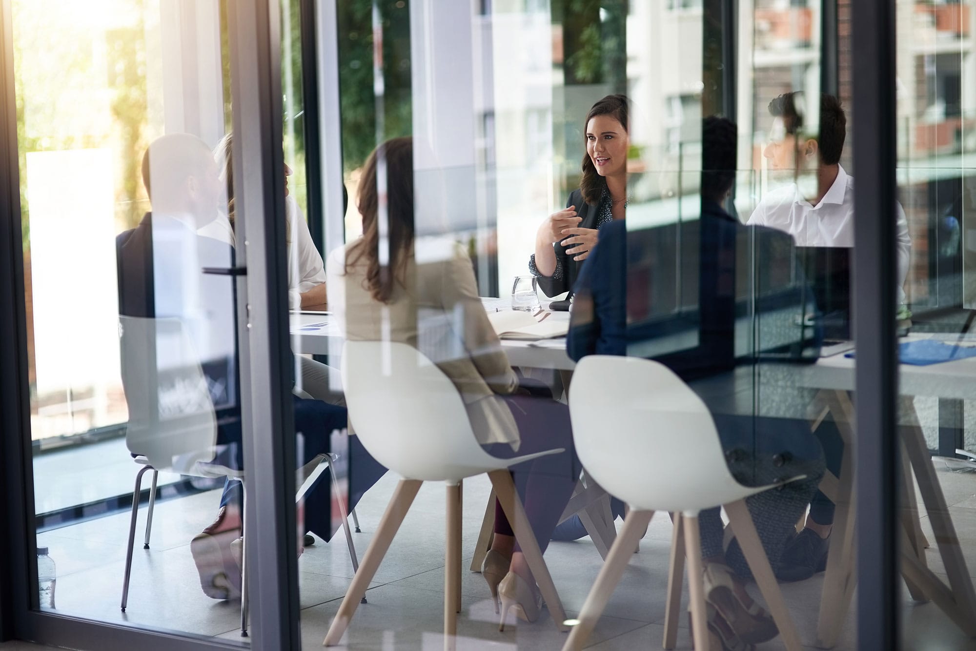 team-in-meeting-room-behind-glass