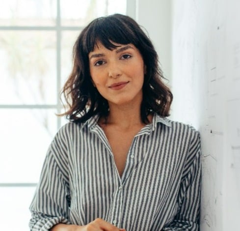 Business woman leaning against wall-1
