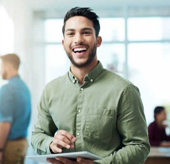 Man smiling with ipad in his hand